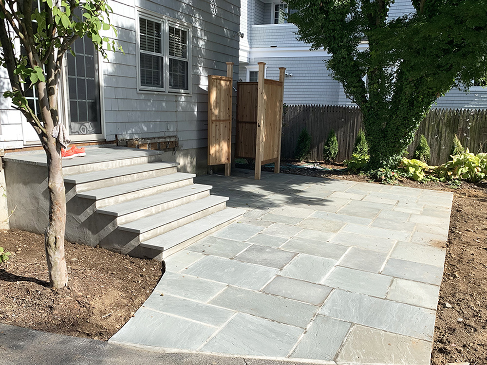 A2Z Contracting's experienced and skilled stone masonry team completed a professional stone patio and steps. The addition of a custom wood outdoor shower creates a true outdoor oasis.